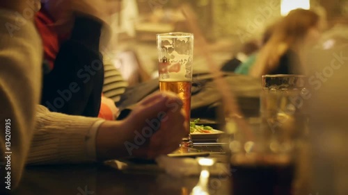 people sit in the evening in the pub and drinking beer.