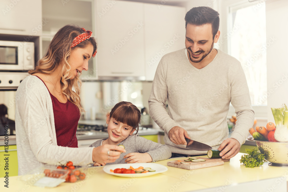 Happy young family in the kitchen