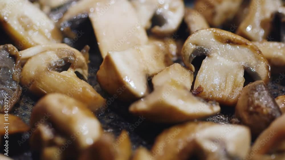 Juicy slices of fried ceps prepared in a frying pan. Fried in vegetable oil Juicy slices of fried ceps prepared in a frying pan. Fried in vegetable oil
