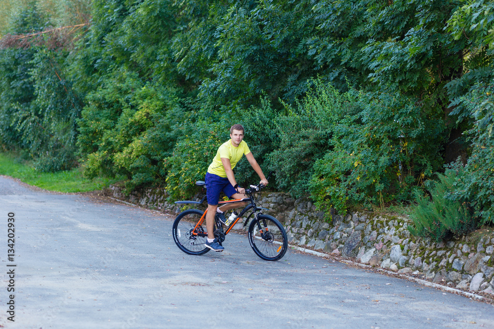 A young guy on a bike outdoors