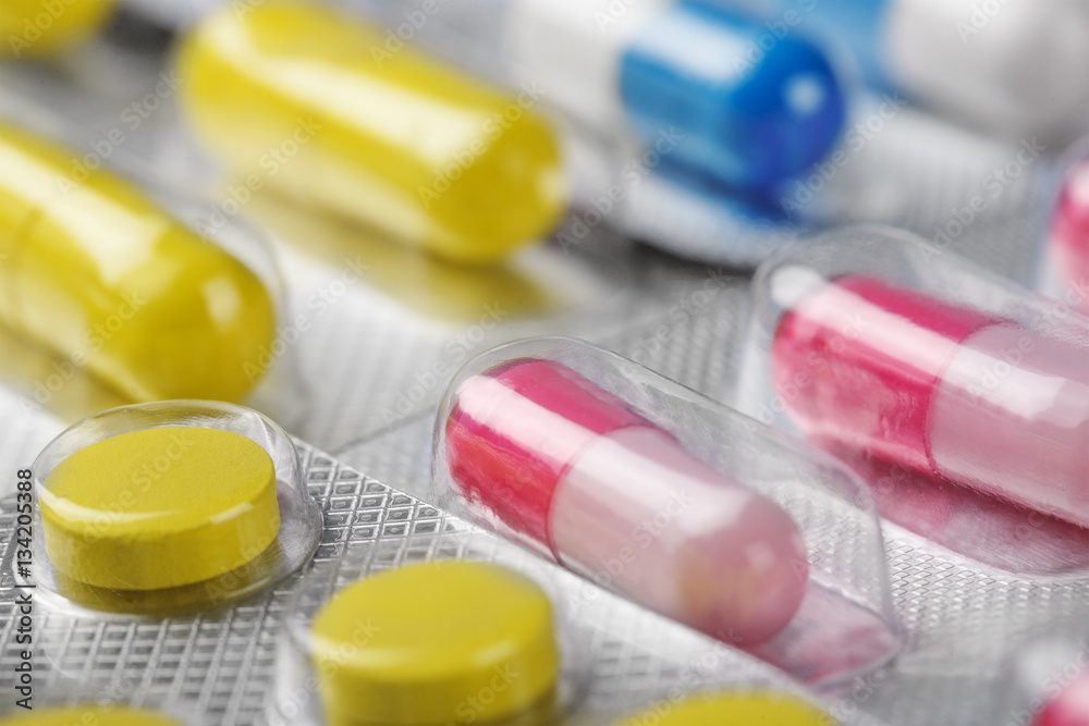 Boxes with red medical pills and yellow pills Boxes with red medical pills and yellow pills