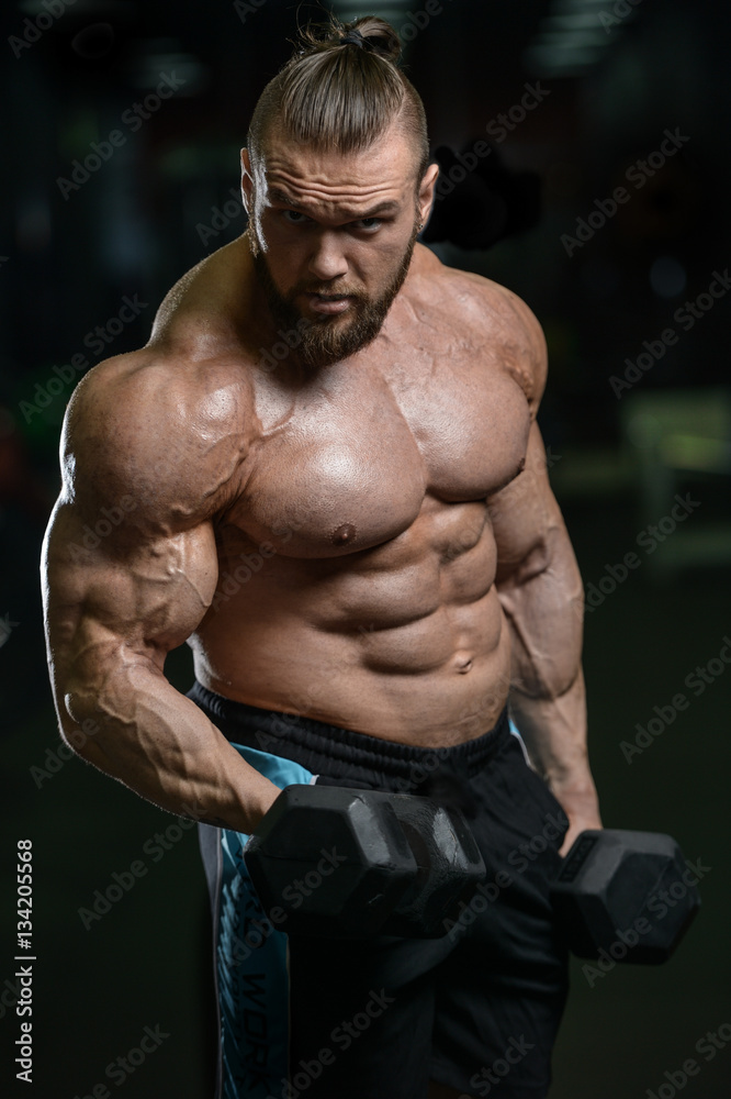 Fototapeta premium Brutal strong bodybuilder athletic men pumping up muscles with d