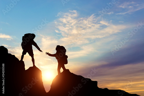 Climber reaches out to his partner by helping each other