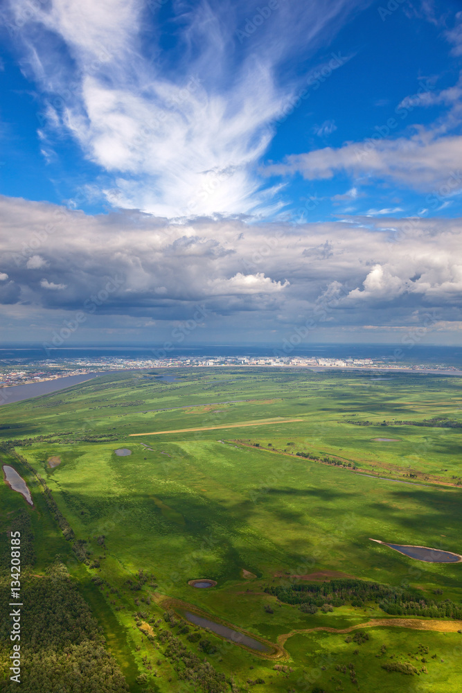 Fototapeta premium Top view over floodland of river Ob and Nizhnevartovsk city