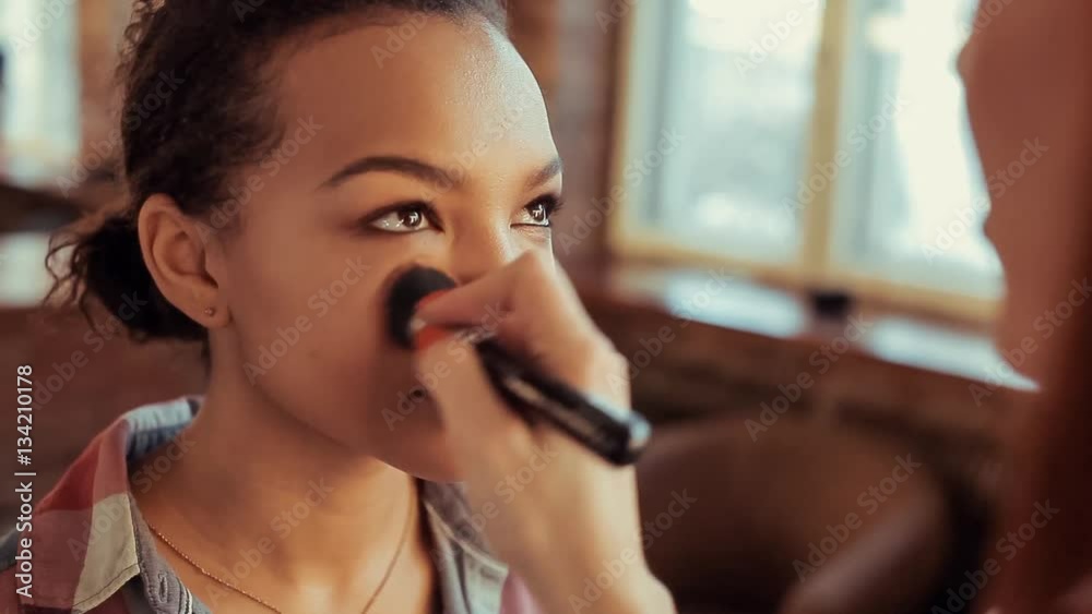 Make up artist doing make up using profesional makeup brush. Make up artist doing make up using profesional makeup brush.
