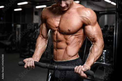Handsome fitness model train in the gym gain muscle