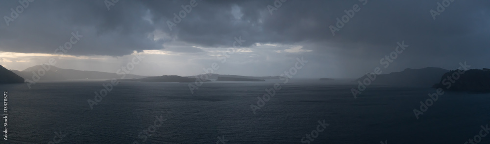 Rainy weather panorama over the sea. Rain on the water surface and stormy sky and clouds