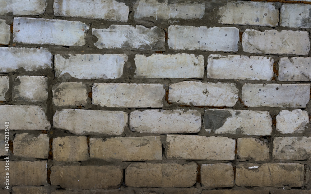 Fototapeta premium The texture of the brickwork. Roughly stacked bricks. Horizontal background.