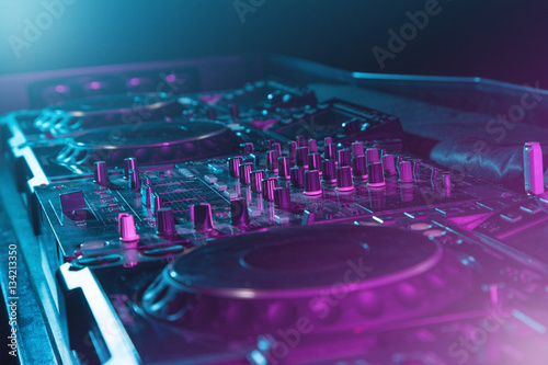 DJ sound equipment at nightclubs and music festivals, EDM, future house music and so on. Parties concept, sound technique. DJ playing on the best, famous CD players.