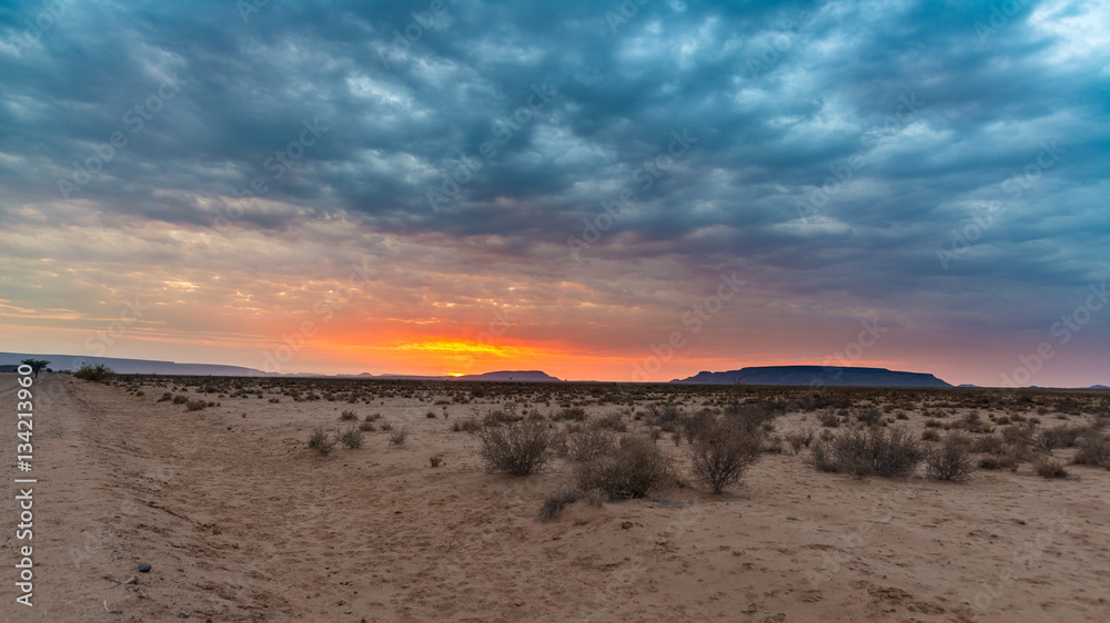 Sunrise over The Namib desert, roadtrip in the wonderful Namib Naukluft National Park, travel destination in Namibia, Africa. Morning light, mist and fog.