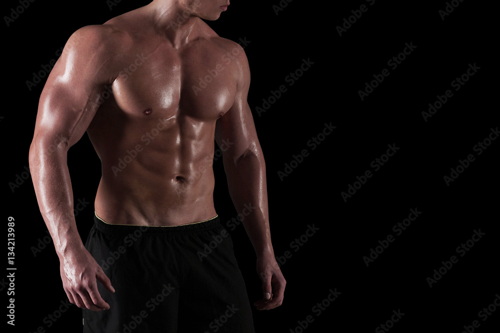 Muscular torso of male bodybuilder isolated. Cropped portrait of athlete with copy space on black background. Muscular torso of male bodybuilder isolated. Cropped portrait of athlete with copy space on black background.