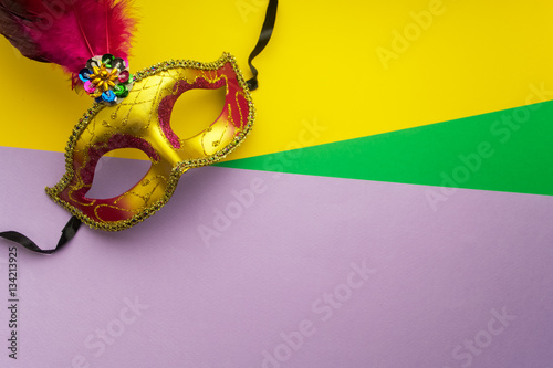 Colorful mardi gras or carnivale mask on a yellow background. Venetian masks. top view.