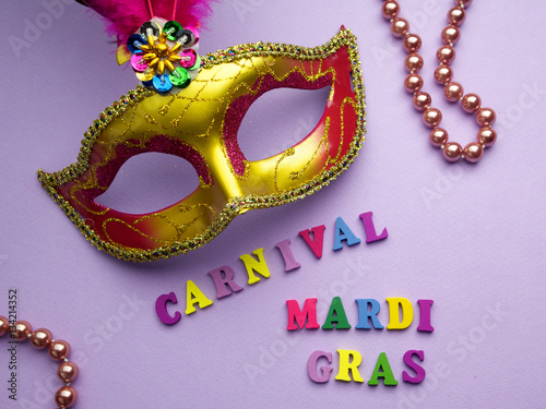 Colorful mardi gras or carnivale mask on a purple background. Venetian masks. top view.
