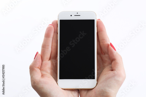 Female hands holding white smartphone
