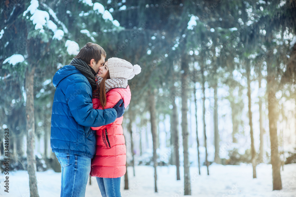 woman and man having fun in winter forest