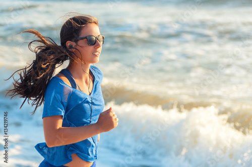 Fitness woman running at sunrise