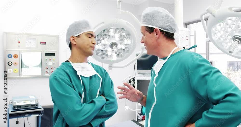 Male surgeons interacting with each other in operation room Male surgeons interacting with each other in operation room
