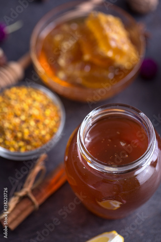 Jar of natural honey on table top view.