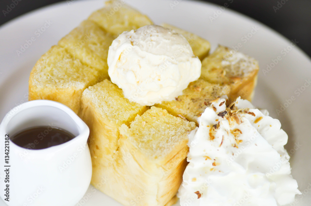 Honey toast with vanilla ice cream , whipped cream and syrup