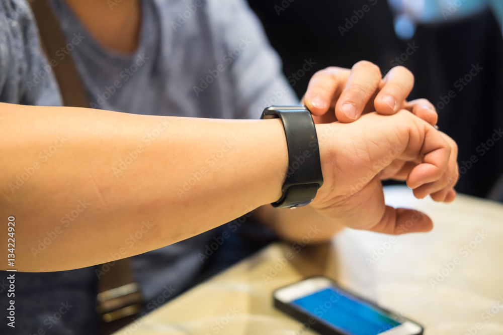Fototapeta premium Male using smart watch in the restaurant
