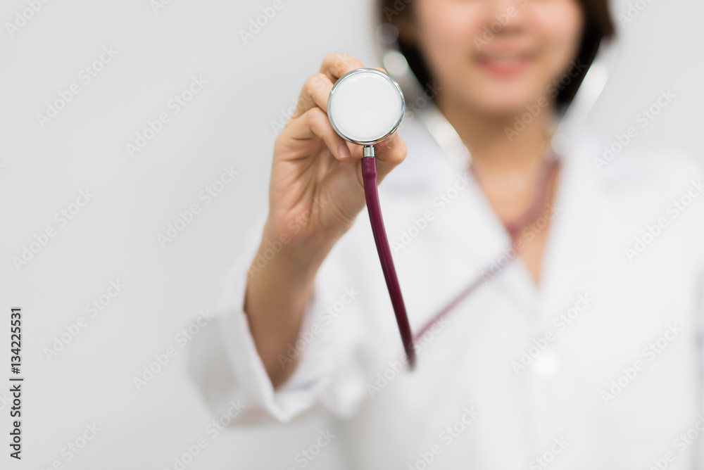 Young Asian woman doctor showing stethoscope. Healthcare and medical concept Young Asian woman doctor showing stethoscope. Healthcare and medical concept