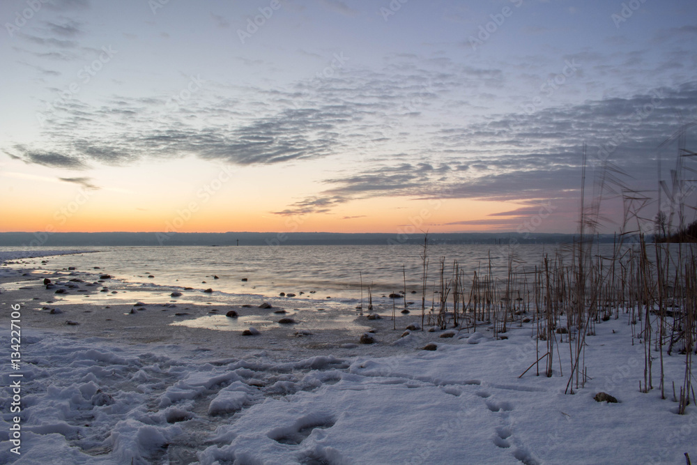 Faszinierender Sonnenuntergang am winterlichen Seeufer