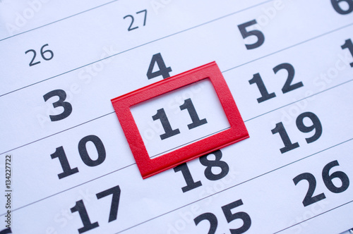 White paper calendar with the number 11  in the red box