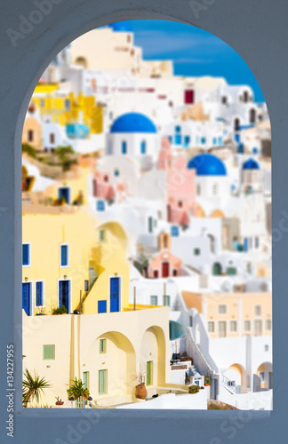 Oia village in window frame, view of Ia town, Santorini island, Greece