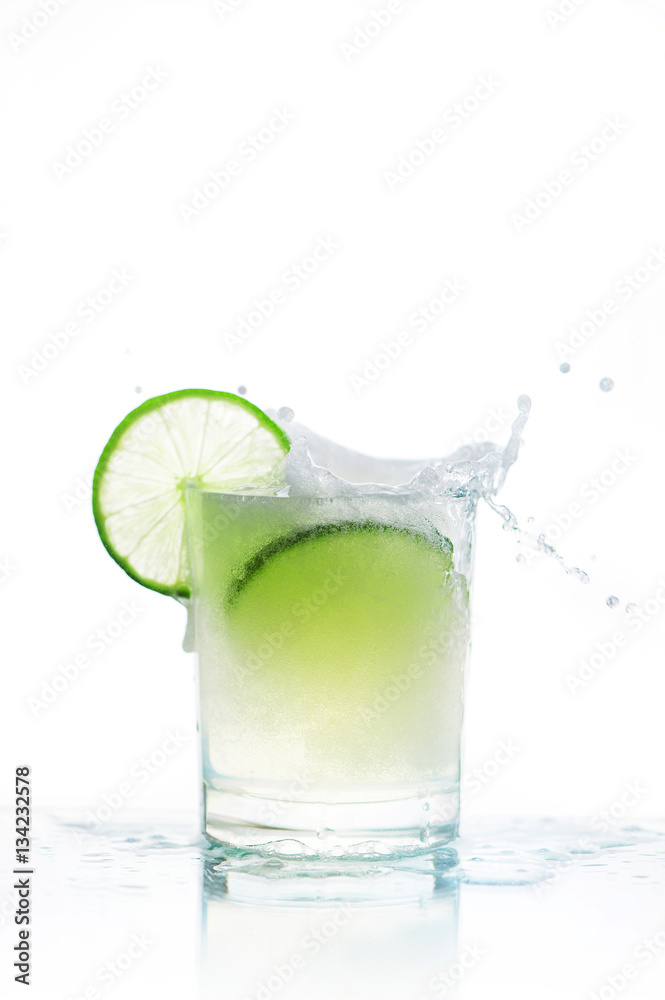 Glass of soda and lime, pured bavarage and splashes Glass of soda and lime, pured bavarage and splashes