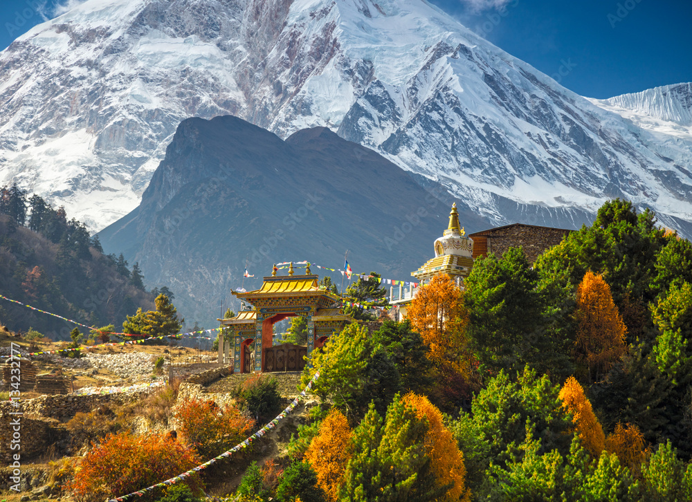 Buddhist monastery and Manaslu mount in Himalayas, Nepal.  View from Manaslu circuit trek - obrazy, fototapety, plakaty 