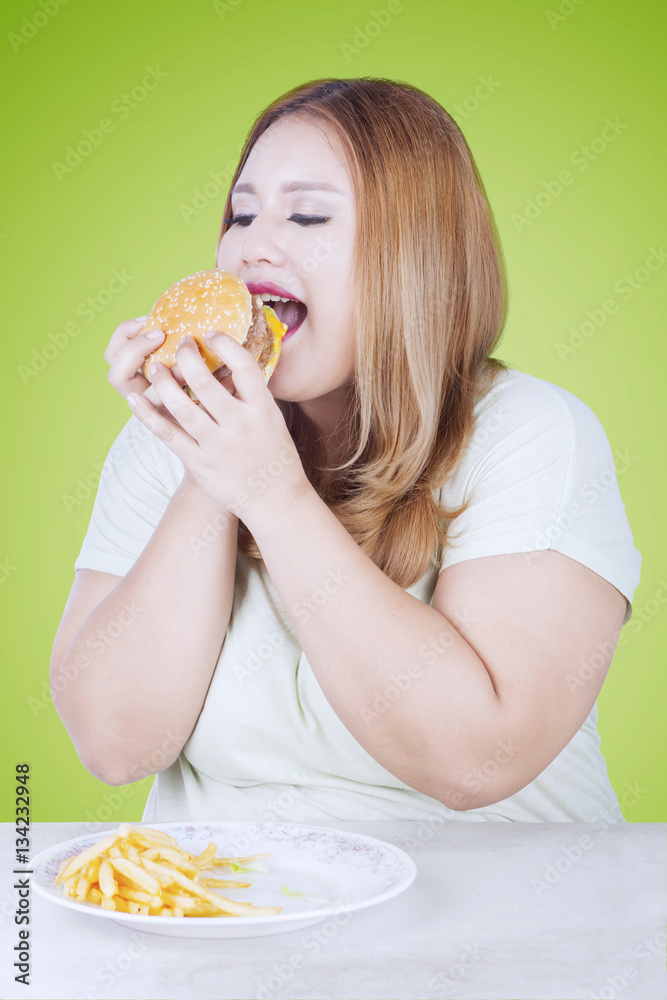 Beautiful blonde woman eats hamburger Beautiful blonde woman eats hamburger