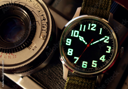 vintage black watch close up over vintage camera