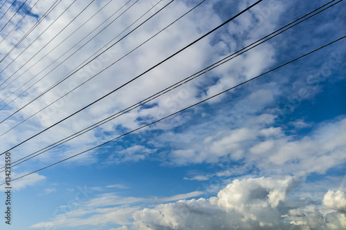 Electricity lines on a cloudscape with copy space. 