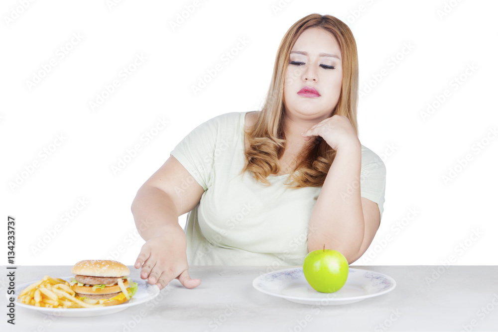 Blonde woman refuses hamburger Blonde woman refuses hamburger