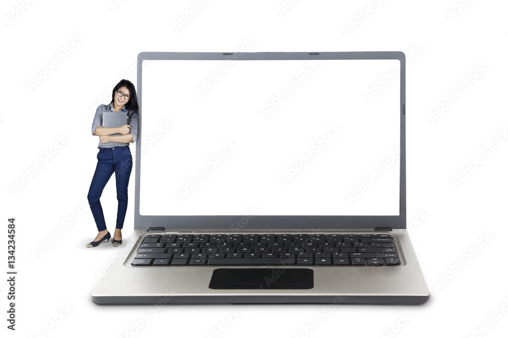 Fototapeta premium Businesswoman leaning on big laptop