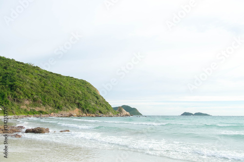 the green big mountain with sea sand sun and the beach on sunshine day and bright sky and cloud background.