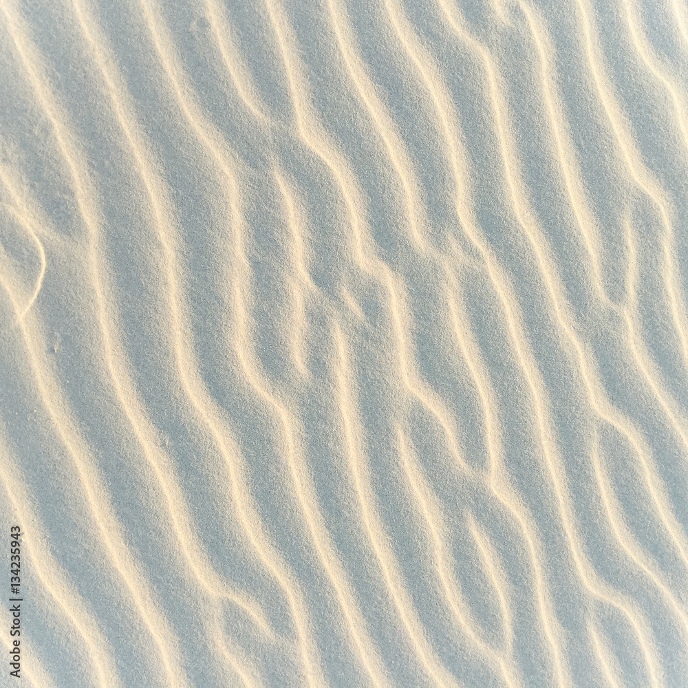 Closeup of sand pattern of a beach in the summer. Beach background. Top view Closeup of sand pattern of a beach in the summer. Beach background. Top view