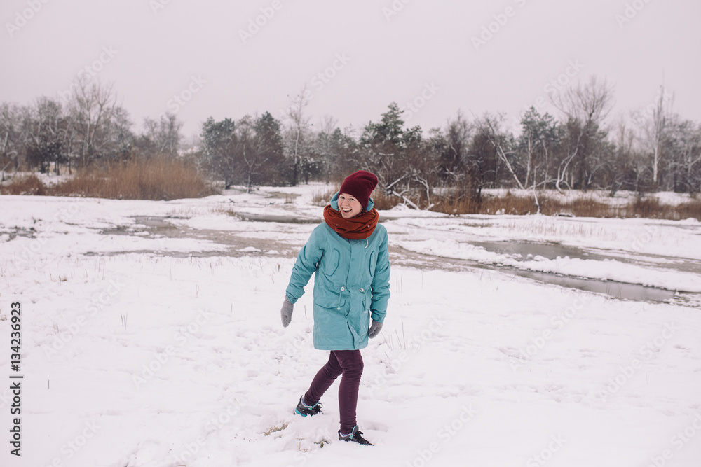 young woman walking in the in winter park