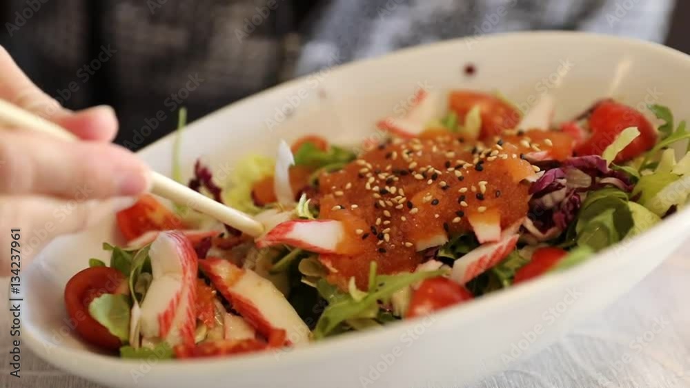 Salad of sashimi and shrimp with tomatoes and smoked salmon. Japanese fusion food, Asian cultures. Healthy food, light diet concept. Slow motion effect. Salad of sashimi and shrimp with tomatoes and smoked salmon. Japanese fusion food, Asian cultures. Healthy food, light diet concept. Slow motion effect.