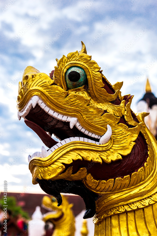 Fototapeta premium Buddhism dragon guard statue in sunlight, Thailand. Religion