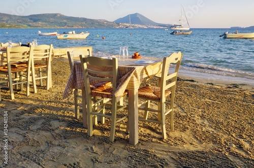 Table set on the beach at a traditional Greek taverna restaurant in Messenia, Greece