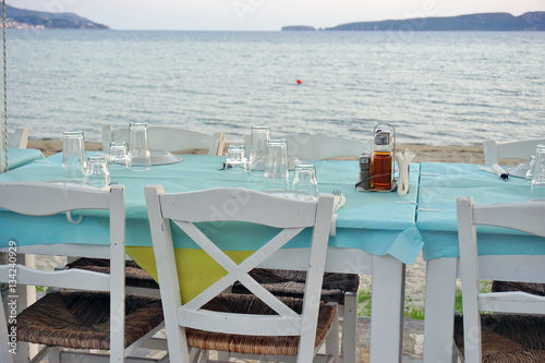 Table set on the beach at a traditional Greek taverna restaurant in Messenia, Greece
