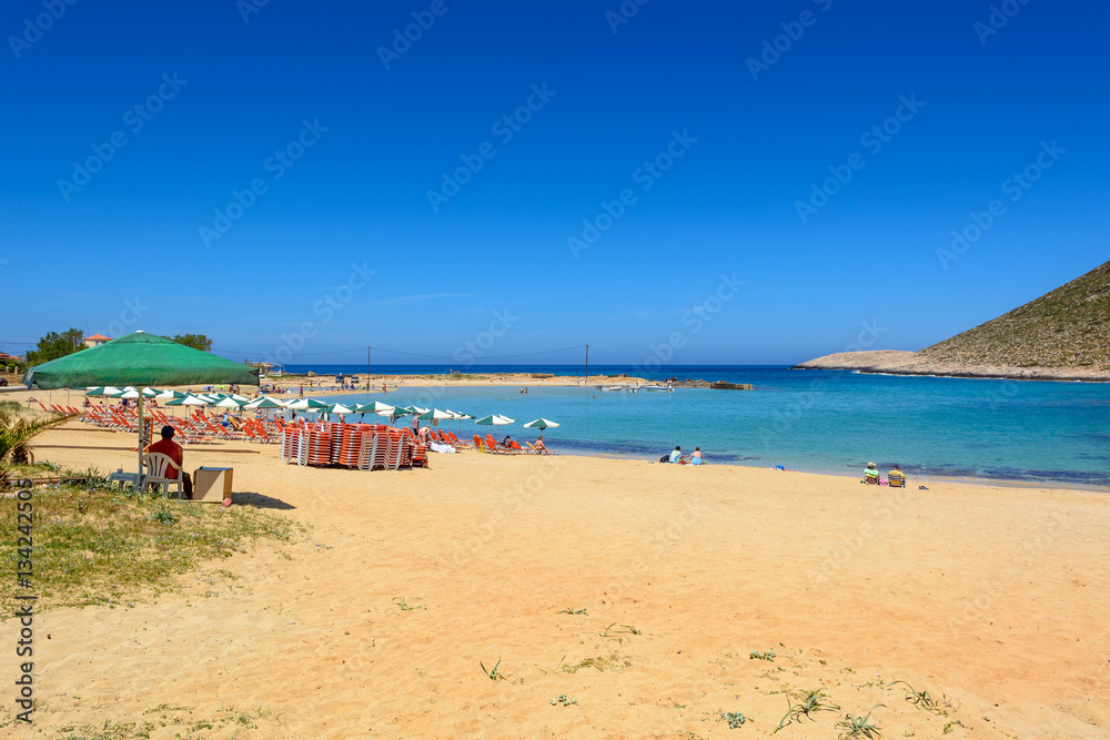 Tourists relax and bath on the Stavros beach, made famous by Anthony Quinn the film Zorba the Greek. Crete island, Greece. 