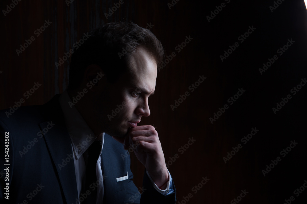 Portrait of a businessman on black background