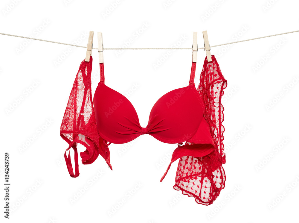 Red female panties and bra hanging on rope Stock Photo
