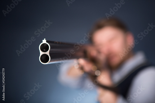 Quadro su tela Office worker holding a shotgun