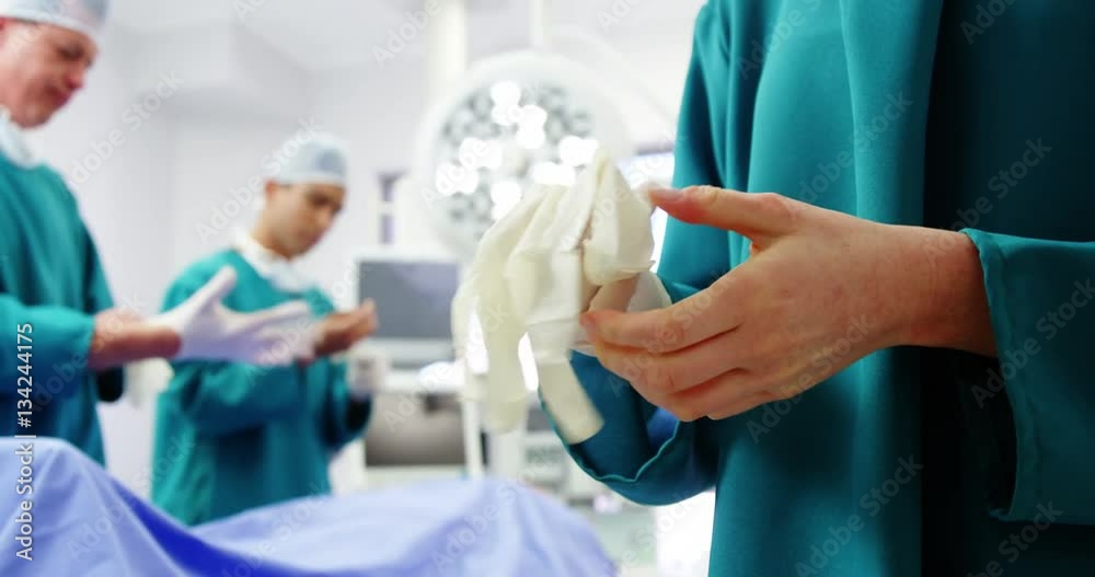 Surgeons wearing surgical glove Surgeons wearing surgical glove