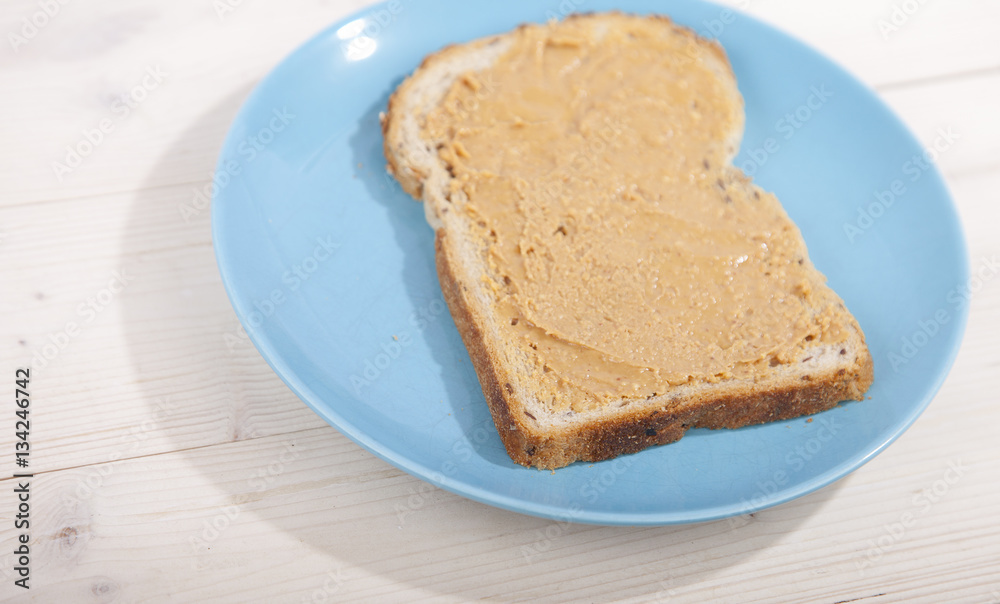 Bread with peanut butter on wooden background Bread with peanut butter on wooden background