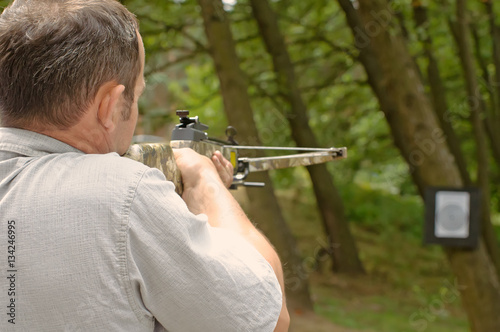 Canvas Print Man shoots with a crossbow.