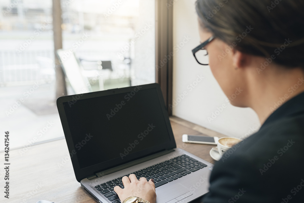 Businesswoman using his laptop and mobile in the Coffee Shop. Businesswoman using his laptop and mobile in the Coffee Shop.